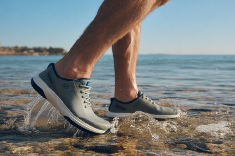 Man wearing best water shoes for men walking on wet beach rocks with quick dry and anti slip design
